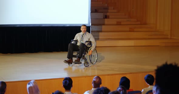 Businessman speaking on stage in auditorium 4k