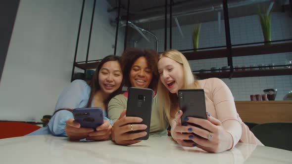 Carefree Multiethnic Females Taking Selfie Shot in Coffee Shop