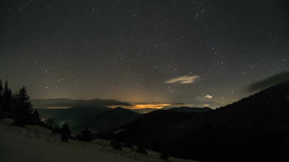 Starry Night Sky with Stars and Low Clouds Moving over Mountains Nature Astronomy