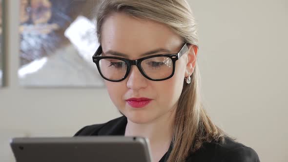 Young Female Business Entrepreneur Presses And Swipes Across Her Tablet 4