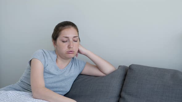 Woman Is Exhausted From the Heat Sitting at Home. She Turns on Air Conditioner From Remote.