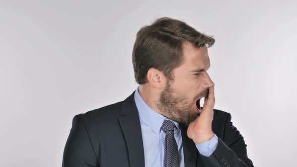 Tired Businessman Yawning on White Background