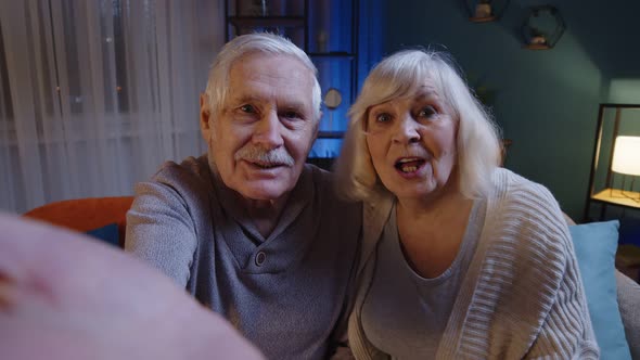 POV of Mature Grandfather Grandmother Making Online Video Call Talking Waving Hand Looking at Camera