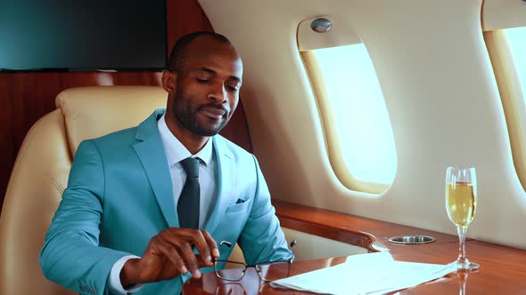 Successful entrepreneur toasting with champagne on his private jet