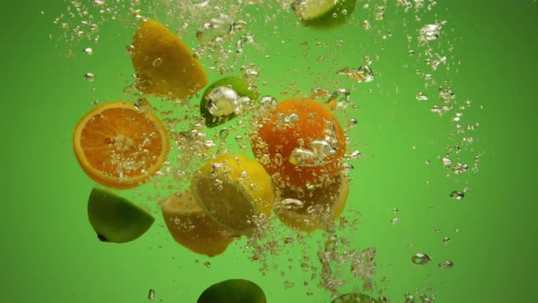 Mix of Exotic Citrus Fruits Falling Into Water in Slow Motion  Orange Lime Grapefruit Lemon