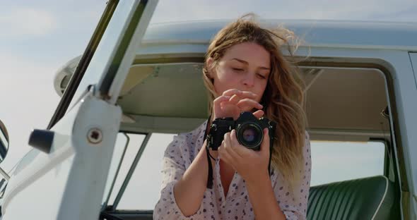 Woman taking photos with digital camera 4k