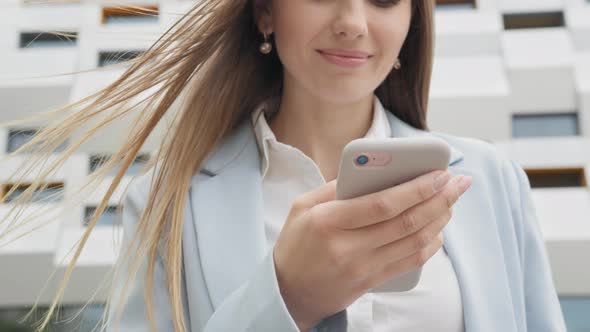 Appealing Young Elegant Woman Using Social Media Application on Smartphone Text