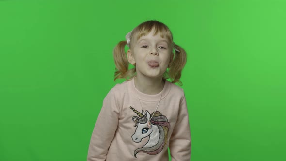 Girl in Unicorn Sweatshirt Show Tongue and Smile. Happy Child. Chroma Key