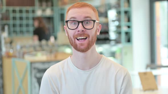 Portrait of Video Chat By Cheerful Redhead Man