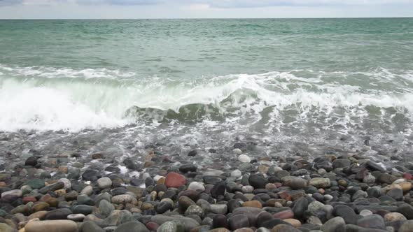 Sea Waves Roll on Pebbles Shore During a Light Storm Slow Motion Slow Motion