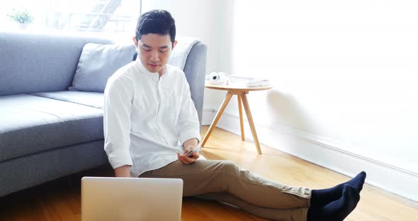 Man using laptop in living room 4k