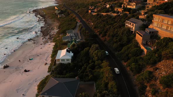 Aerial view of road crossing Scarborough Beach at sunset, South Africa.