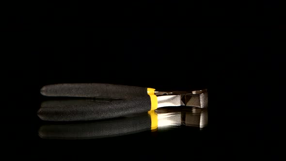 Wire Cutters with Yellow, Gray Handle on Black, Reflection, Rotation