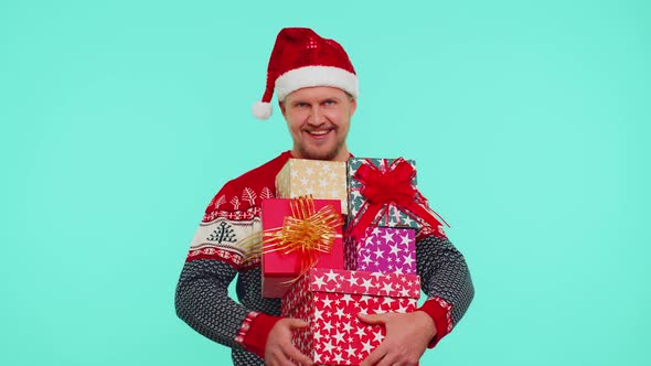 Handsome Stylish Man in Christmas Sweater Holding Many Gift Boxes New Year Presents Shopping Sale