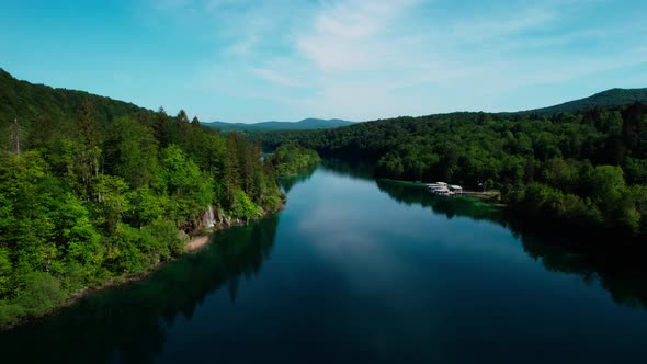 drone fly above water lake formation in Plitvice croatia national park travel holiday destination in