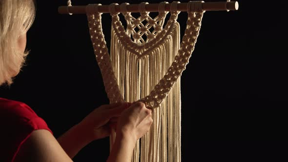 Women's Hands Weave a Macrame Pattern in Creative Workshop on Black Background