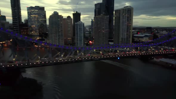 Aerial Pan shot of Story Bridge by night on Brisbane River, Queensland