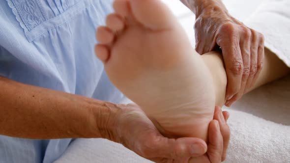 Close up of woman therapist massaging the feet of her patient