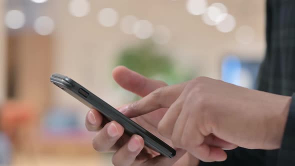 Close Up of African Hands Using Smartphone