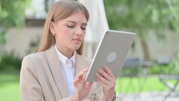 Outdoor Young Businesswoman Browsing Internet on Tablet