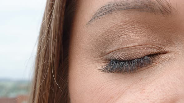 Brown Woman's Eye Close Up. The Woman's Eye Slowly Closes and Opens. Perfect Female Eye.