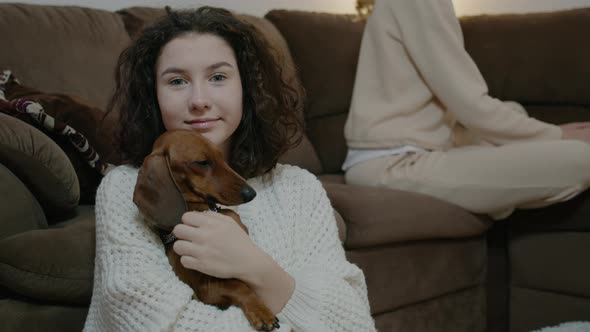 Girl Playing with Dog and Sitting on Couch in Apartment Interior Indoors Rbbro