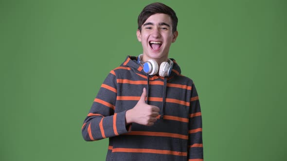 Young Handsome Iranian Teenage Boy Against Green Background