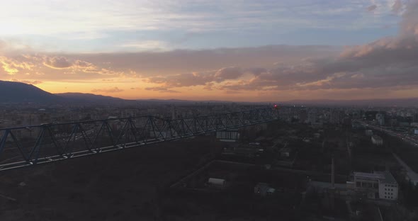 Unfinished Concrete Building with Construction Tower Crane Against Mesmerising Sunset Clouds