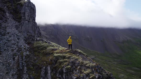 Drone Of Man In Yellow Standing On Mountain