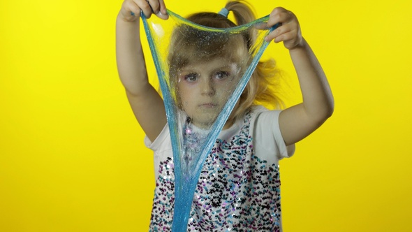 Kid Playing with Hand Made Toy Slime. Child Girl Having Fun Making Turquoise Slime. Antistress