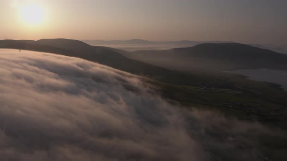 Early morning clouds drift over the mountains in Co Kerry Ireland as the sun shines during the summe