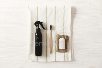 boo toothbrush, handmade shampoo, crystal deodorant on towel, flat lay.  plastic free natural items for personal hygiene