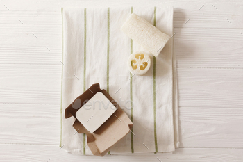  eco handmade coconut soap and luffa on towel, flat lay. plastic free items for  personal hygiene. go green