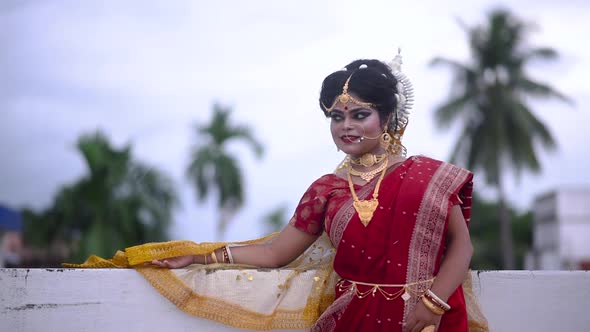 Happy Indian Bride smiling and relaxing outdoor on cloudy evening