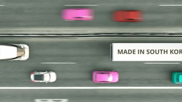 Aerial Overhead View of Semitrailer Trucks with MADE IN SOUTH KOREA Text