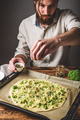 Man cooks pizza with broccoli and pesto sauce - PhotoDune Item for Sale