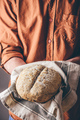 Man holds a freshly baked rye bread - PhotoDune Item for Sale