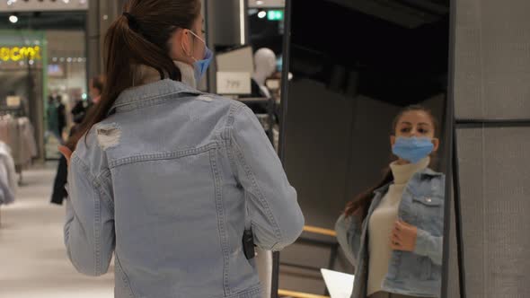 Shopper Fixes Long Hair in Ponytail Trying Blue Denim Jacket