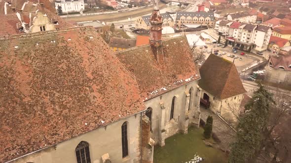 A drone shot, with capturing an architechtural property in the city of Sighisoara on an afternoon