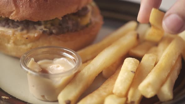 Close Up of Hand Pick Fresh Fries