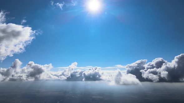 Aerial View From Airplane Window at High Altitude of Earth Covered with White Puffy Cumulus Clouds