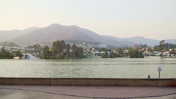 Stabilized walking shot while panning up to reveal a waterfront view of the town in Las Lagunas, La