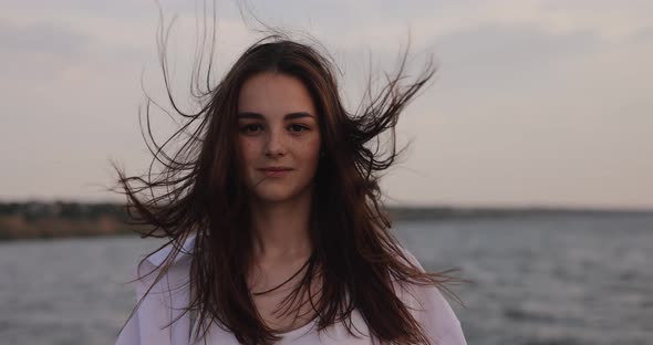 Slow Motion Wind Blowing Hair of Young Smiling Woman