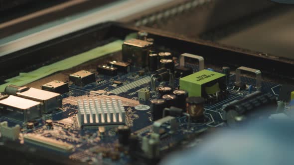 Worker install elements on an electronic circuit board at a TV factory