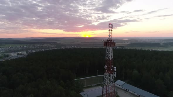 Aerial view of Mobile Communication Tower in forest in village at sunset 11