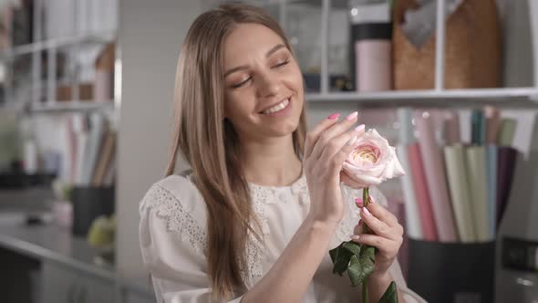 The Woman Rejoices at the Beautiful Flower in Her Hands