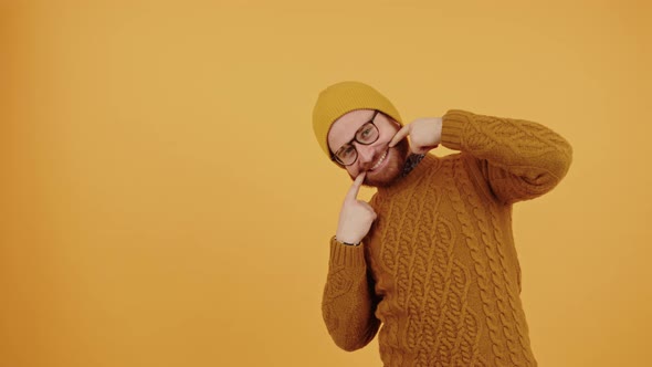 Smiling European Touches Edges of His Mouth Yellow Background Isolated Studio Shot Copy Space