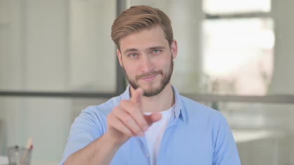 Portrait of Young Creative Man Pointing at Camera Inviting