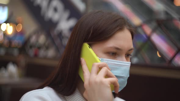 Woman in Protective Mask Talking on the Phone Smiling at Airport Public Center