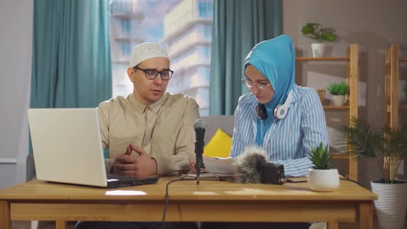 Young Muslim Woman and a Muslim Man Record an Interview Podcast While Sitting in Front of a